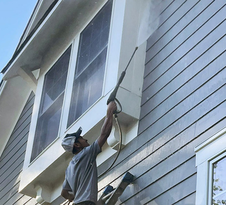 Sean Hadden Painting employee performing interior wood staining services.