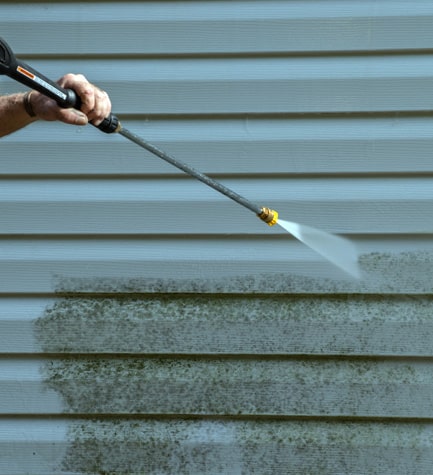 Sean Hadden Painting during a commercial power washing service in Carmel, IN.